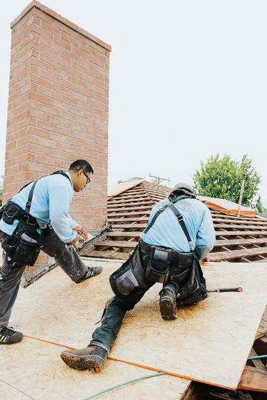 workers working on a new roof